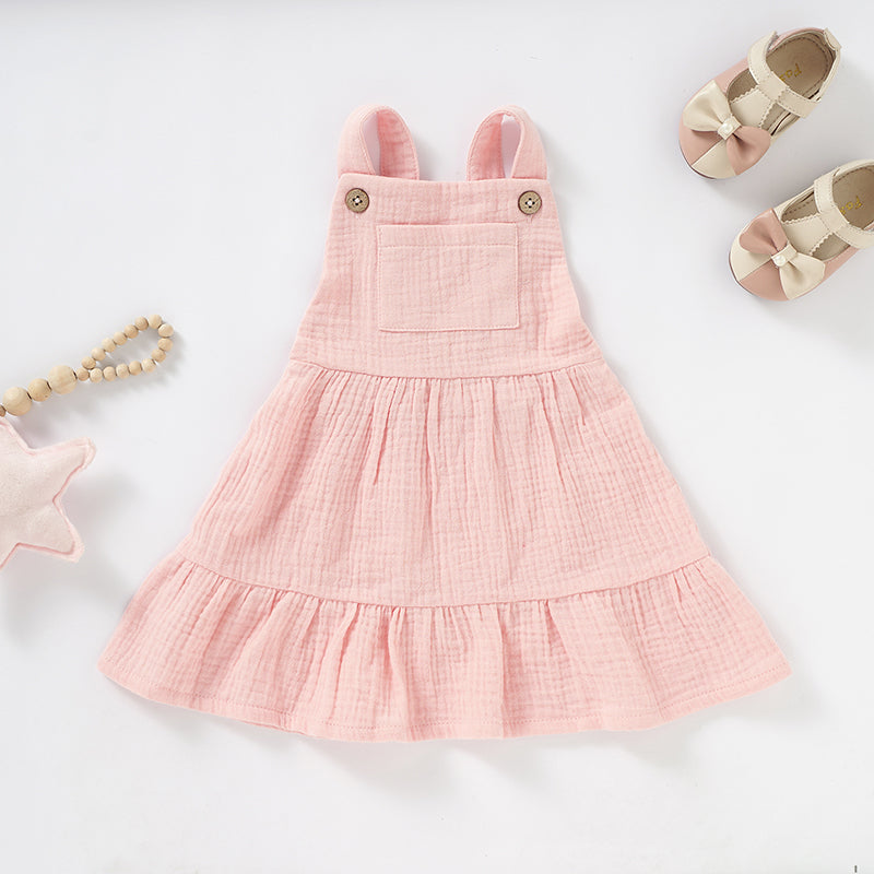 Organic cotton muslin baby dress featured in Roo & Thread’s guide to building a simple natural-fiber baby wardrobe.